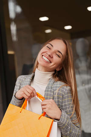 Content young woman carrying shopping bagsの写真素材