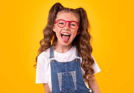 Funny girl in glasses showing tongue