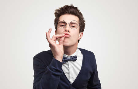 Funny nerd man showing delicious gesture
