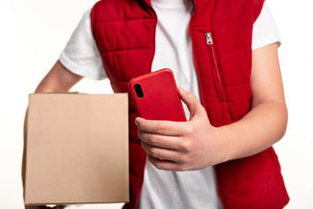 Courier with parcel using mobile app on smartphoneの写真素材