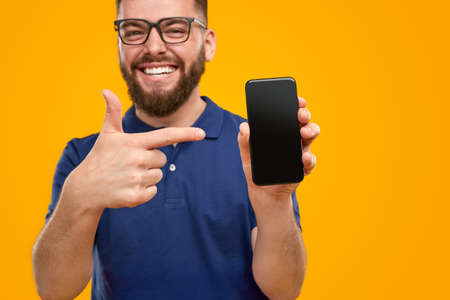 Excited man showing modern smartphoneの写真素材