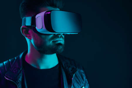 Man in VR goggles experiencing virtual worldの写真素材