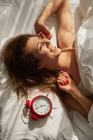 Happy woman waking up in sunny morningの写真素材