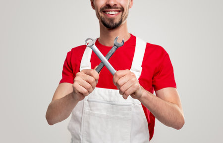Cheerful mechanic with spanner wrenchesの写真素材