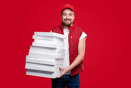 Cheerful delivery man with pizza boxesの写真素材