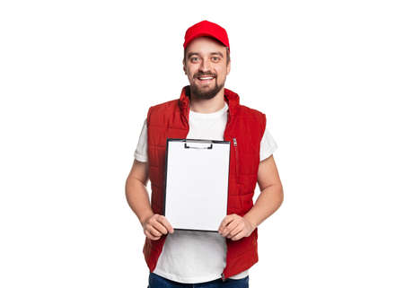 Cheerful courier showing blank clipboardの写真素材