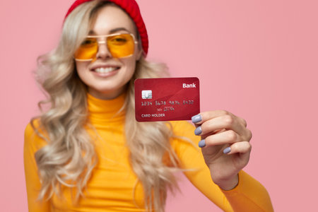 Happy woman showing credit cardの写真素材