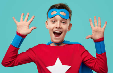 Excited superhero kid showing ten fingers