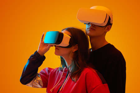 Stylish young couple in VR goggles