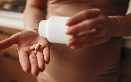 Pregnant woman with vitamins pillsの写真素材
