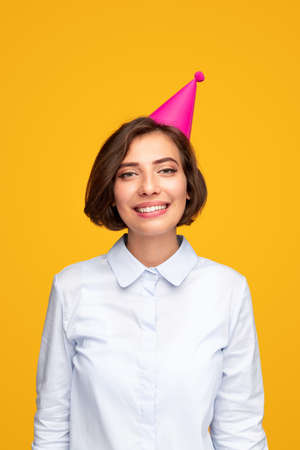 Delighted young woman in party hatの写真素材