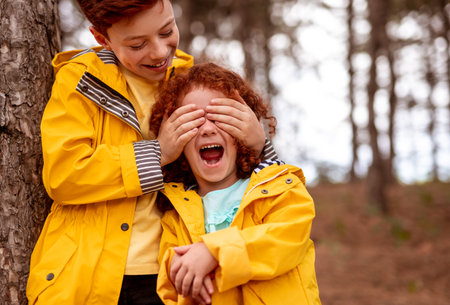 Happy ginger siblings playing in forestの写真素材