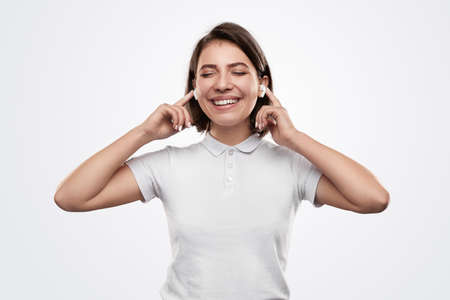 Cheerful woman with earbuds enjoying musicの写真素材