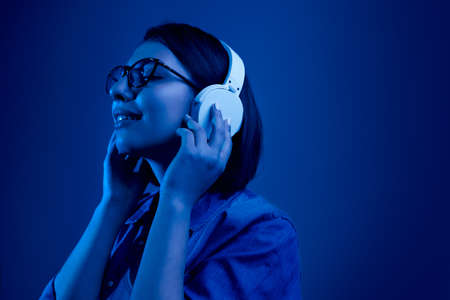 Relaxed woman in headphones enjoying musicの写真素材