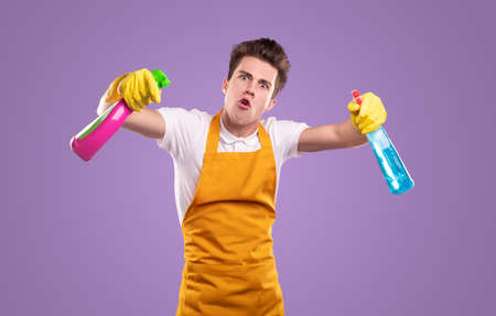 Crazy male housekeeper with detergentsの写真素材