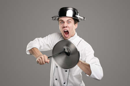 Funny chef pretending to be warriorの写真素材
