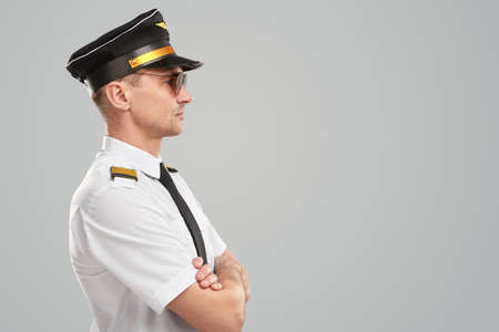 Serious male pilot in uniform in studioの写真素材