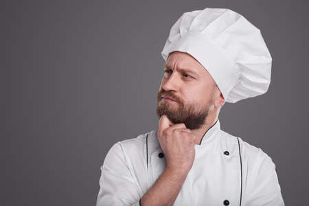 Pensive bearded chef in uniformの写真素材