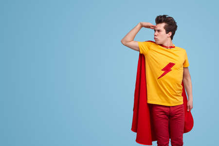 Funny superhero looking away in studioの写真素材