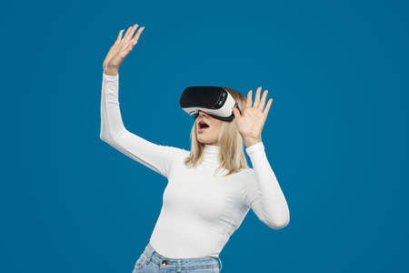 Excited woman playing game in virtual reality glasses