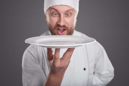 Comic chef with empty plateの写真素材