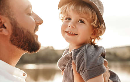 Cute son in arms of fatherの写真素材