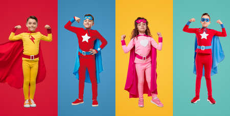 Kids in superhero costumes showing musclesの写真素材