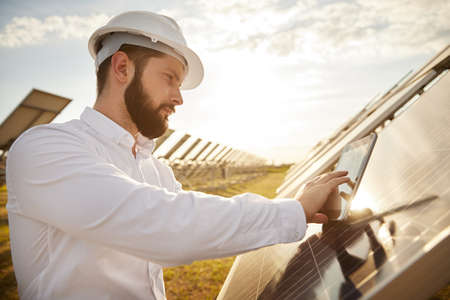 Male engineer configuring solar panelの写真素材