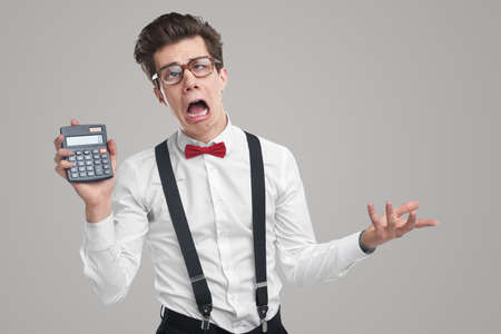 Funny accountant with calculator in studioの写真素材
