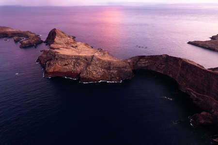 Scenery of rocks in sea in sunsetの写真素材