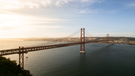 Suspension bridge over river in sunsetの写真素材