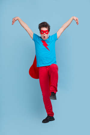 Comic superhero in kung fu posture in studioの写真素材