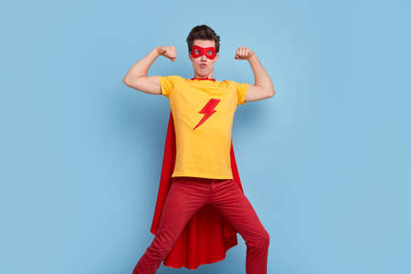 Comic muscular superhero showing bicepsの写真素材