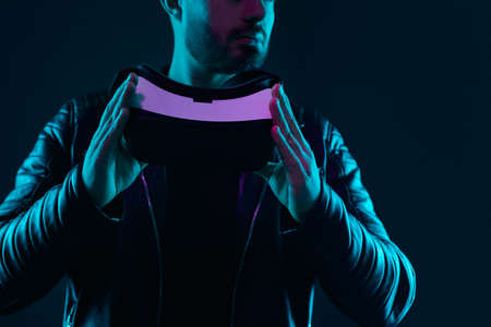 Crop man with VR glasses in darknessの写真素材