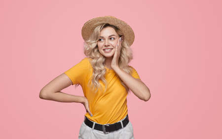 Stylish blond woman touching cheekの写真素材