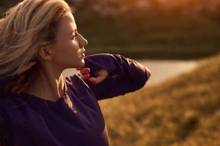 Carefree woman enjoying sunset in nature