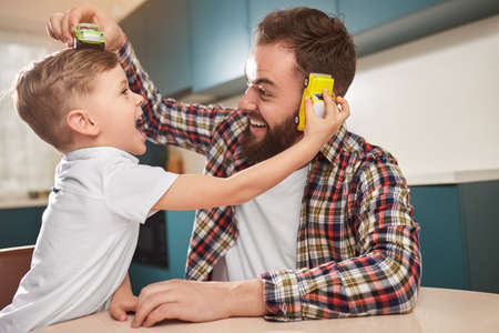 Father and son playing with toy carsの写真素材