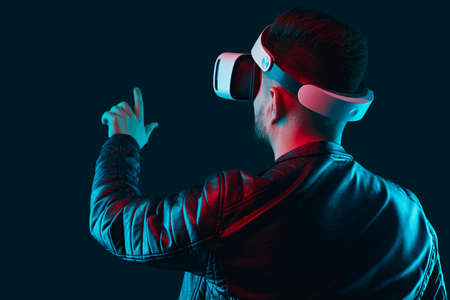 Man interacting with virtual reality in VR headsetの写真素材