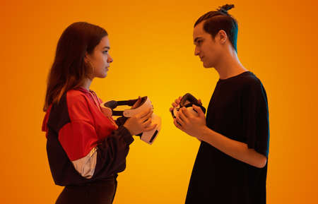 Young couple with VR goggles in studioの写真素材