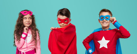Preteen children in hero costumes in studioの写真素材