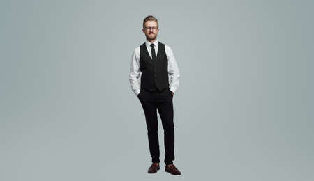 Positive businessman with hands in pocketsの写真素材