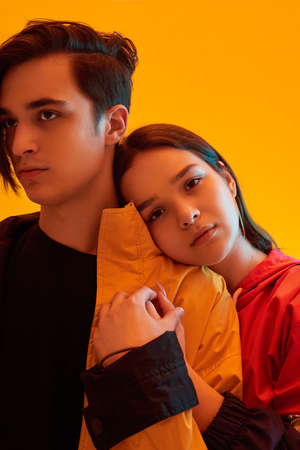 Young stylish couple of teenagers in studio