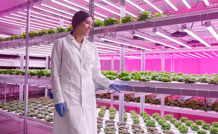 Delighted woman in laboratory with green lettuce