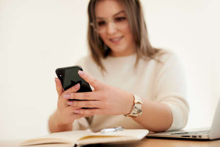 Woman using smartphone during remote work