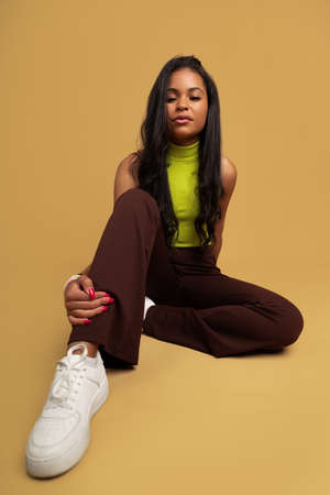 Self assured Hispanic teenager touching legの写真素材