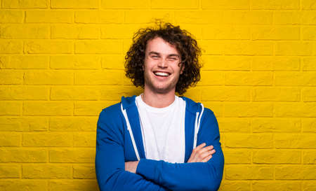 Happy man with crossed arms
