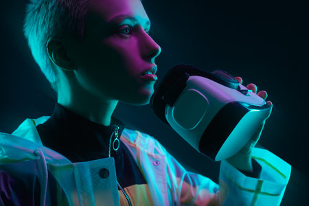 Young woman taking off VR headset