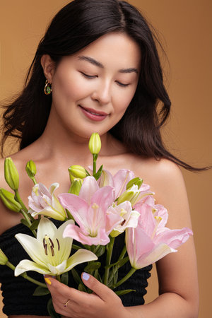 Asian female with bouquet of liliesの写真素材