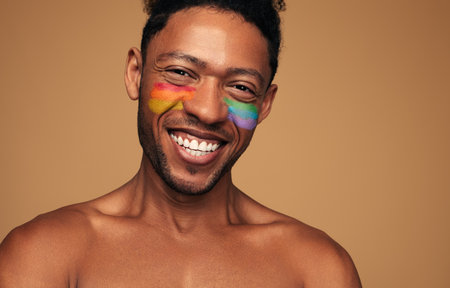 Cheerful black gay looking at camera with smileの写真素材