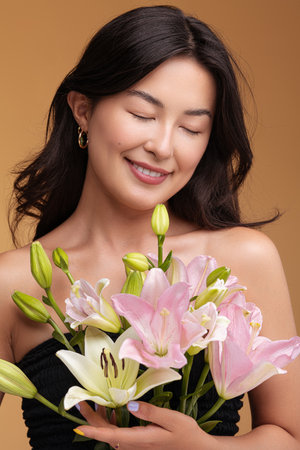 Glad Asian woman with fresh bouquetの写真素材